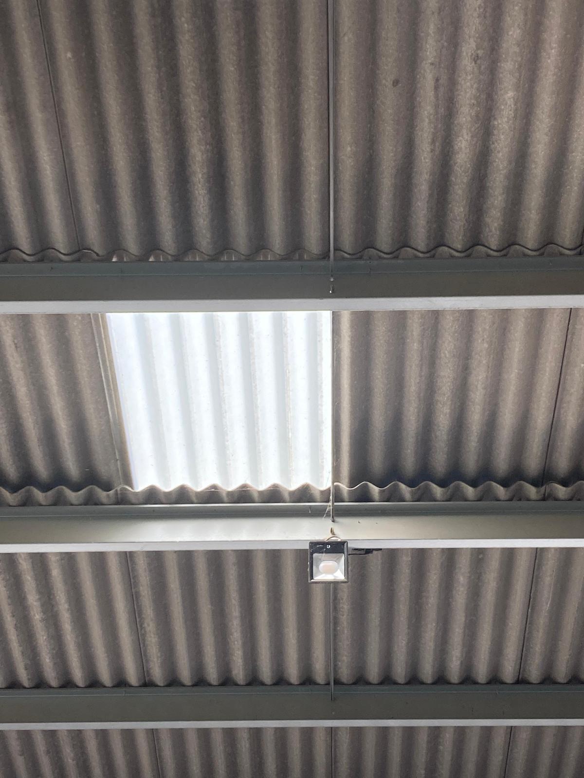 An electric floodlight positioned next to a rooflight.